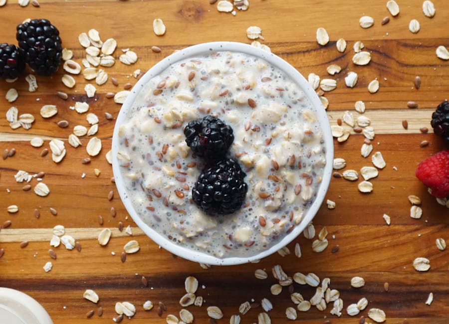 A delightful bowl of overnight oats with blackberries and flax seeds, perfectly styled for food photography.