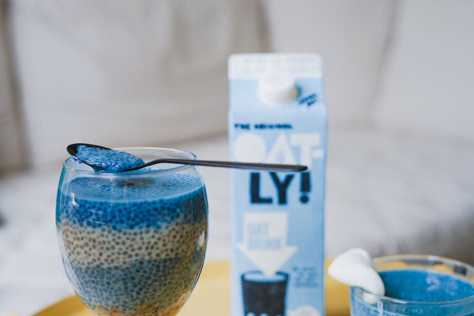 Delicious blue chia pudding served in glass with oat milk for a beautiful, healthy snack.