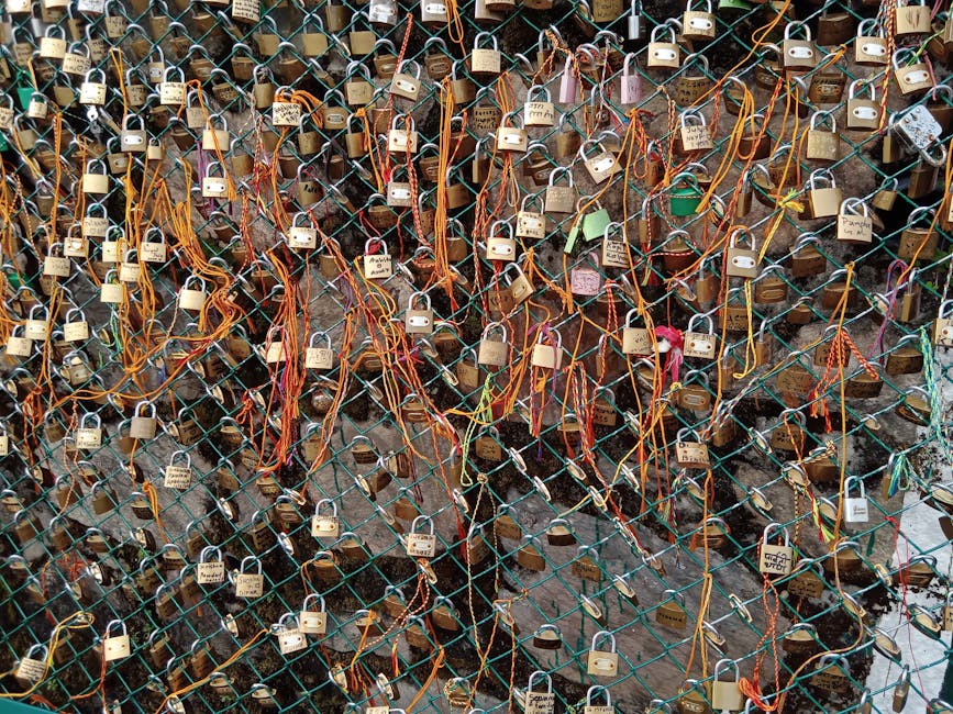 A vibrant display of love locks attached to a fence with colorful ribbons.