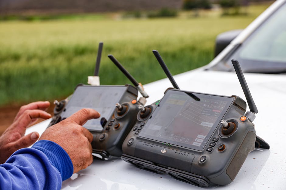 Close-up of farmers using drone controllers on a farm for precision agriculture.