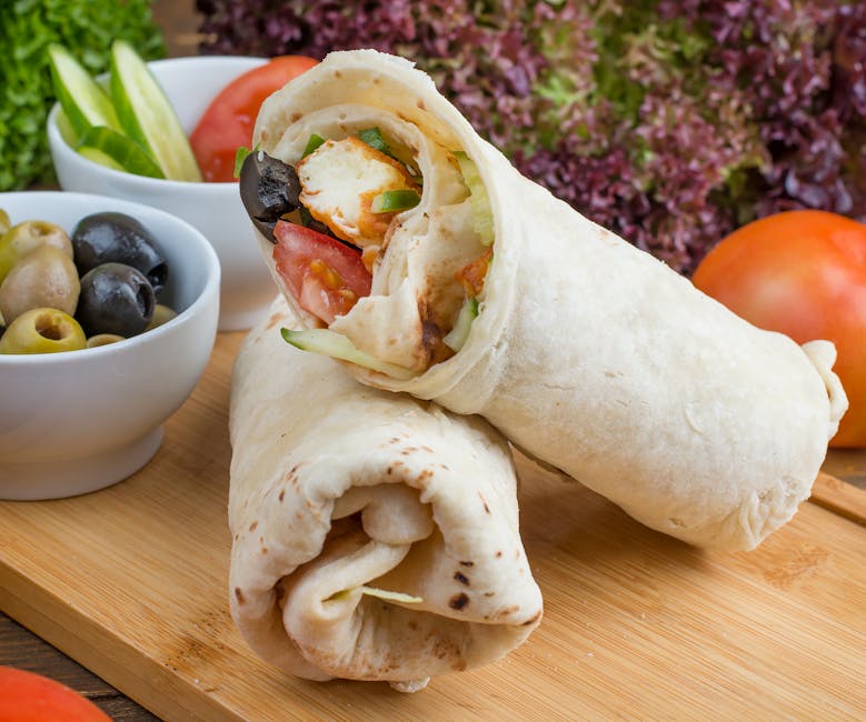 Delicious Mediterranean-style chicken wrap served with olives and fresh vegetables, perfect for lunch or dinner.